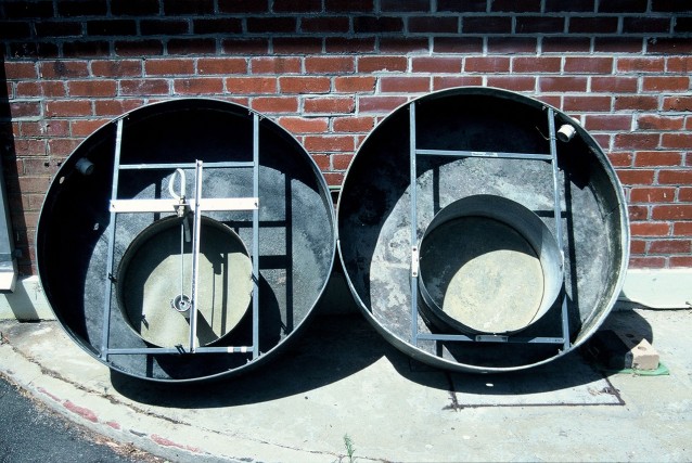 Basic pan experiment layout, photographed after pans were decommissioned, February 1998. The experiment pans are mounted eccentrically within the Class A thermal regulation pans. The eccentric mount pattern kept the pans close to the centre of the shelter, precluding rain contamination of the experiments. Lake water circulated through the outer pans at about 1900 litres/hr and kept the experiment pans within 1 degree C of lake surface temperature.